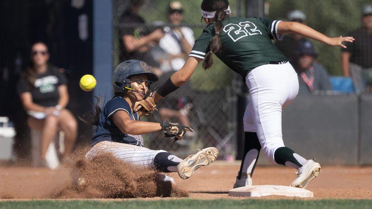 Central Catholic’s Taryn Calderon steals second base as the throw gets past Manteca’s Sienna Owen during the Sac-Joaquin Section Division 3 semifinal playoff game at Central Catholic high School in Modesto on Wednesday, May 20, 2025.