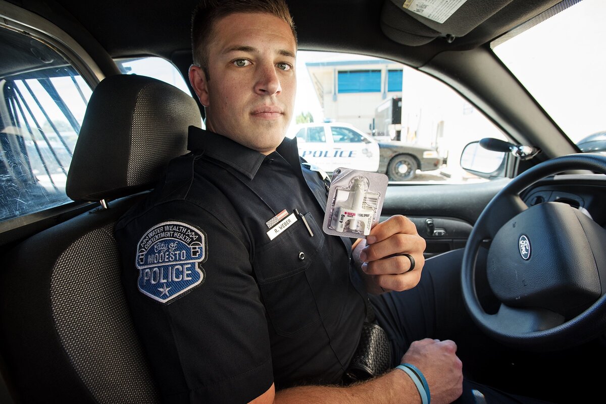 Modesto Police officer Robert Weber shows the Narcan that he keeps with him during patrol in Modesto, Calif., Thursday, June 28, 2018.