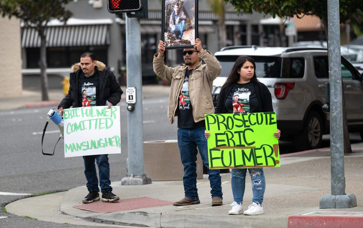 Family and friends of Saul Betancourt, including his sister Maria Madrigal, right, and Luis Servin, middle, protest outside the Stanislaus County District Attorney’s Office in Modesto, Calif., Friday, April 7, 2023. About 25 protesters gathered outside the Stanislaus County DA’s Office on Friday to demand criminal charges against a former sheriff’s deputy involved in a fatal crash in January 2022.