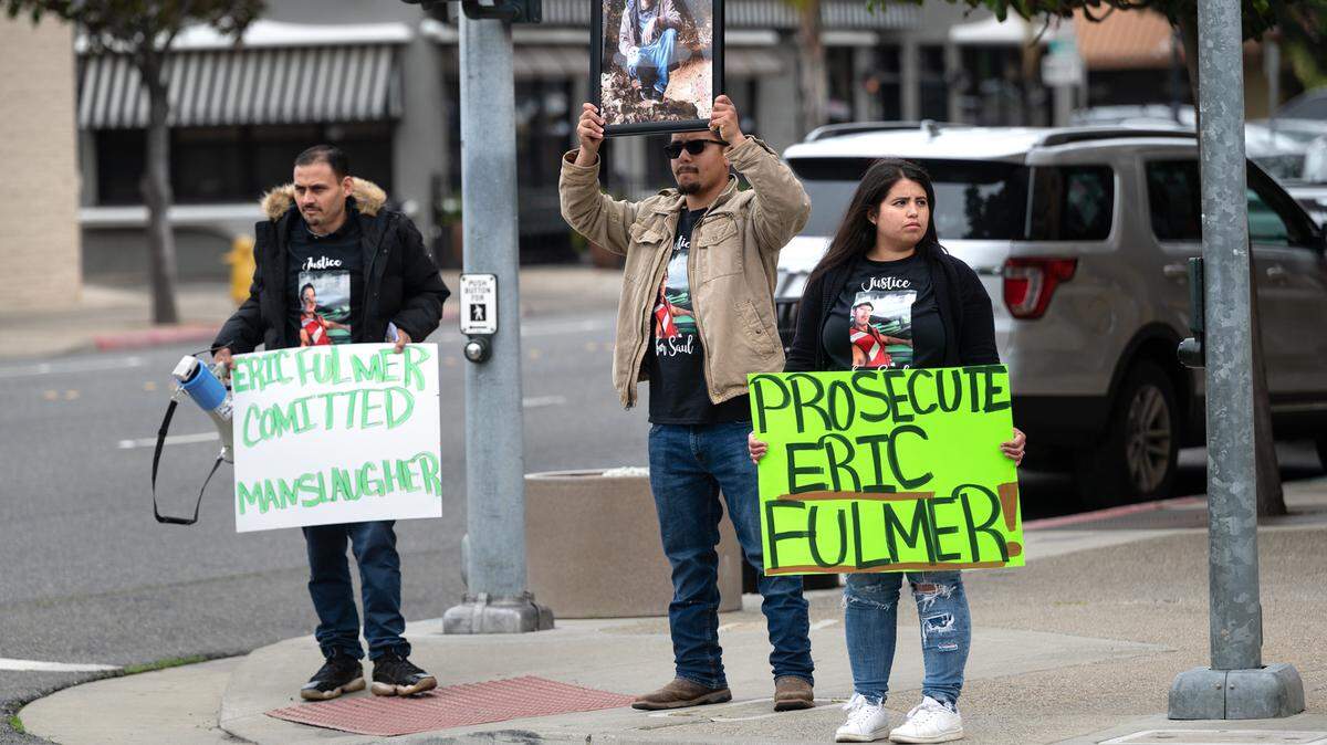 Family and friends of Saul Betancourt, including his sister Maria Madrigal, right, and Luis Servin, middle, protest outside the Stanislaus County District Attorney’s Office in Modesto, on April 7, 2023. About 25 protesters gathered outside the Stanislaus County DA’s Office on Friday to demand criminal charges against a former sheriff’s deputy involved in a fatal crash in January 2022.