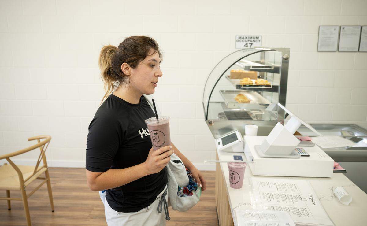 After a jiu-jitsu workout Stephanie Gomez-Briar picks up a protein shake at Rio Juice Brazilian juice bar in Modesto, Tuesday, June 10, 2025.