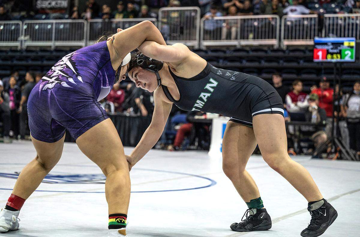 Pitman’s Alana Ontiveros , right, wrestles Dafne Guadarrama of Franklin (Elk Grove) in the 143-pound championship match during the CIF Sac-Joaquin Section Masters Wrestling Tournament at the Stockton Arena in Stockton, Calif., on Saturday, Feb. 19, 2022. Ontiveros took first with a 6-3 win.