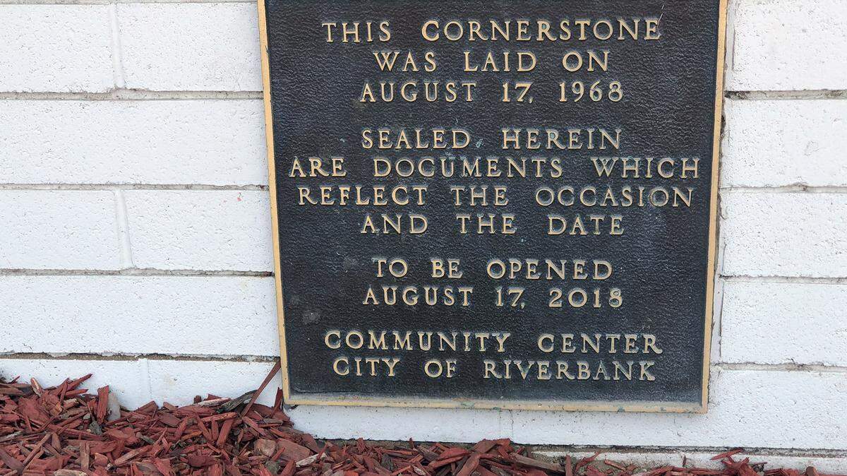 A plaque at the Riverbank Community Center is pictured Friday afternoon August 10, 2018. A time capsule was located at the spot but the contents are missing.