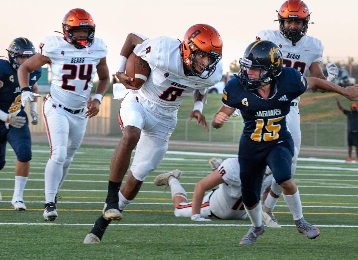 Merced’s Enoch Evans scores past Gregori kicker Jace Guzman after recovering a fumbled snap during the non-league game with Gregori at Gregori High School in Salida, Calif., on Friday, August 26, 2022.