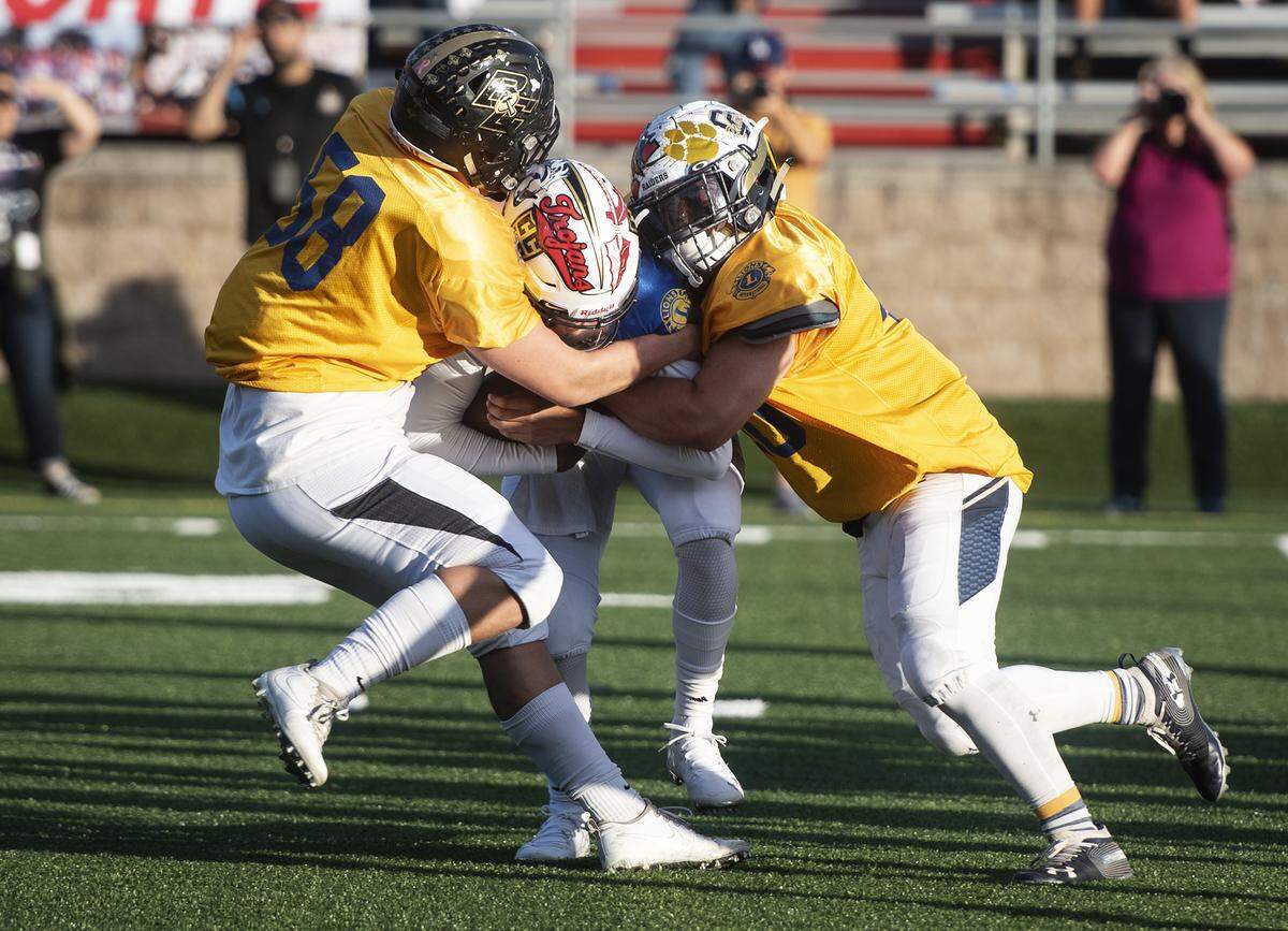 South players Junior Bravo, right, (Central Catholic) and Mason Reel, left, (Buhach Colony) sack North quarterback Giovanni Gonzalez (Chavez) during the Central California Lions All-Star Football game at Lincoln High School in Stockton, Calif., Saturday, June 15, 2019.