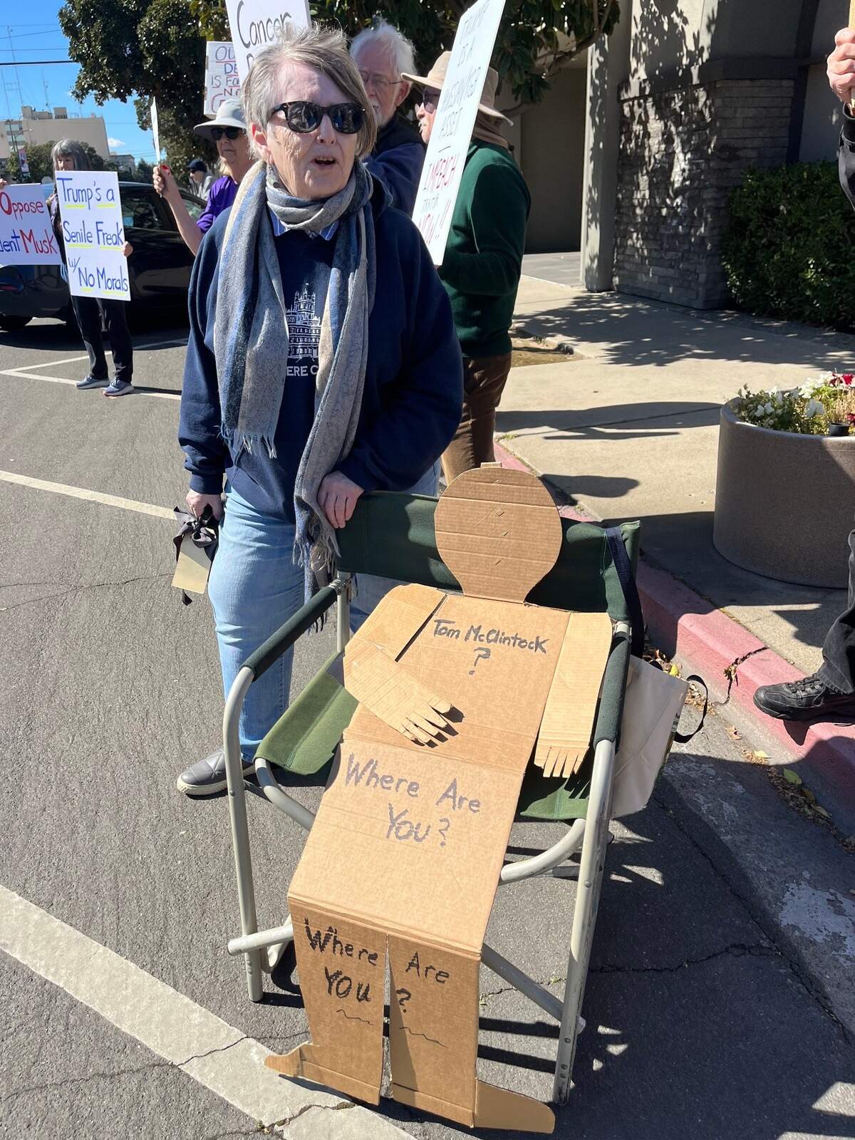 Donna Endsley of Turlock protested with a cardboard cutout of a person that read “Tom McClintock, where are you?”