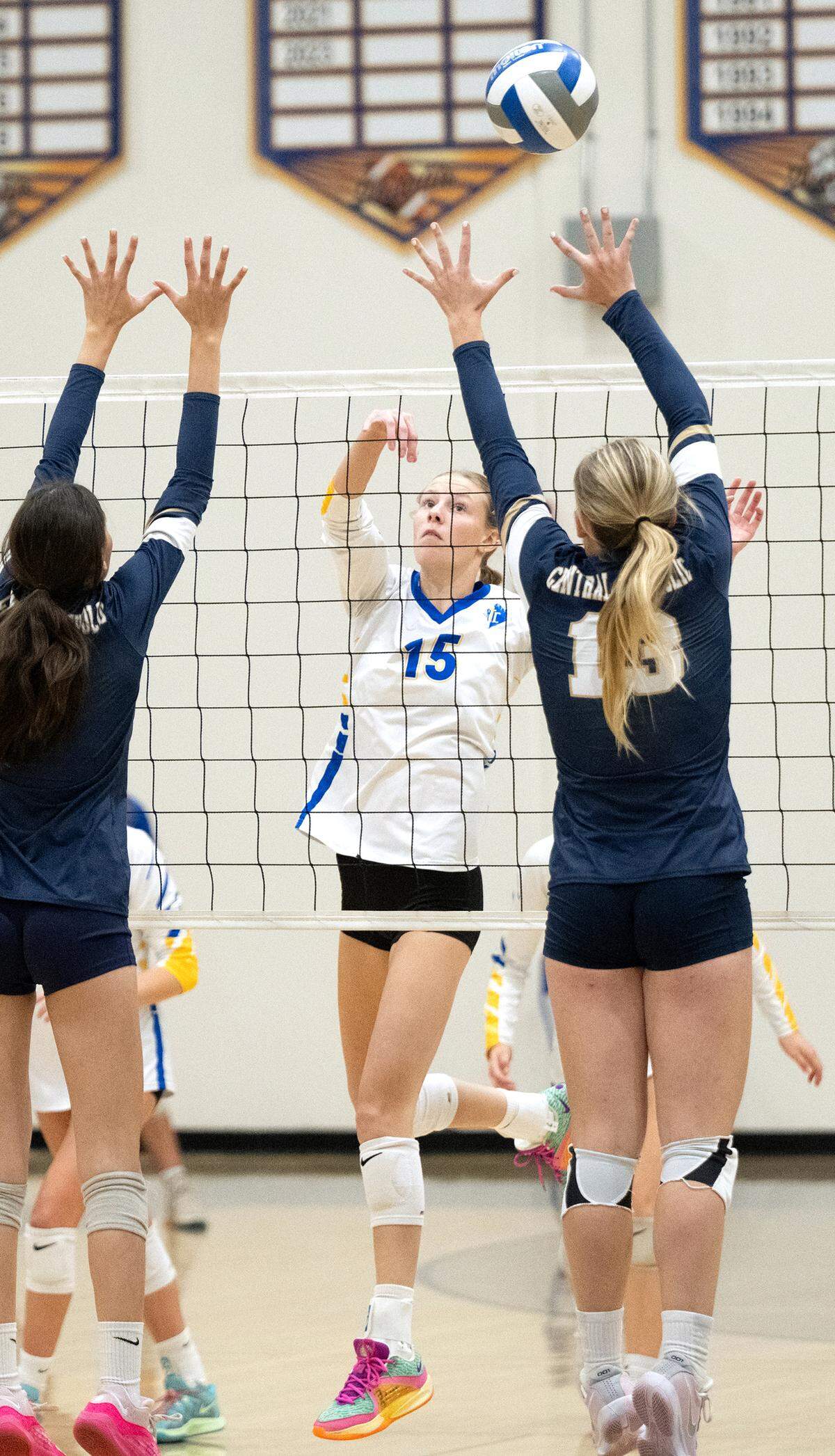 Ripon Christian’s Haley Kootstra (15) flips the ball past two Central Catholic defenders during the Sac-Joaquin Section Division III quarterfinal playoff match at Ripon Christian High School in Ripon, Thursday, Oct. 31, 2024.