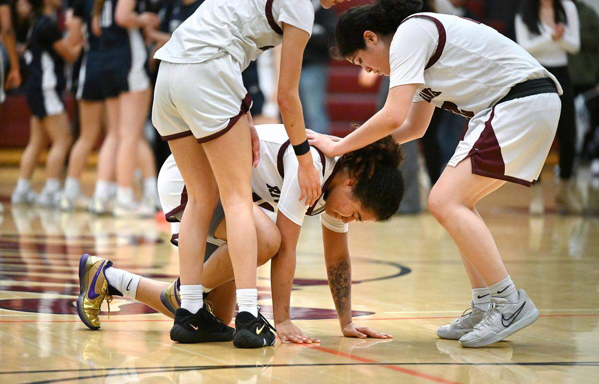 Riverbank’s Chancis Gamez is comforted by teammates Avah Luu, right, and Alexis Felix after the Bruins lost in overtime 46-47 to Notre Dame of San Jose in the CIF Northern California Division IV playoff game at Riverbank High School in Riverbank, Calif., Thursday, Feb. 29, 2024.