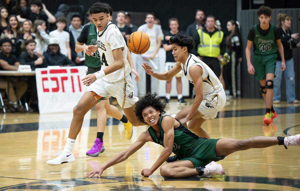 Enochs’ Andrey Donasco forces a turnover from Pitman’s Cole Martin during the Central California Athletic League game at Enochs High School in Modesto, Friday, Jan. 24, 2025.