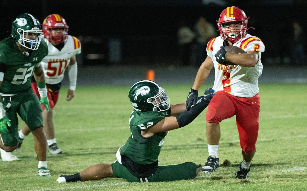 Oakdale’s Richard Flores runs the ball during the Valley Oak League game with Manteca at Manteca High School in Manteca, Friday, Nov. 1, 2024.