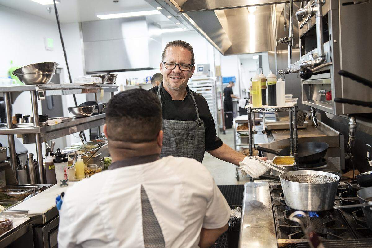 Co-Owner Leroy Walker talks with chef Manny Avina at First & Main Restaurant in Turlock, Calif., Wednesday, Aug. 28, 2019.