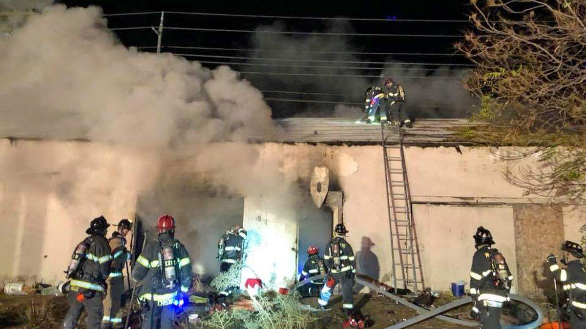 Crews contend with a fire in an abandoned warehouse on Ruffino Drive in Modesto, California, off Yosemite Boulevard on Friday, Nov. 17, 2017.