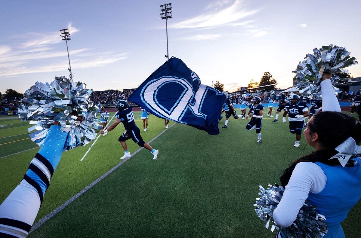 Downey players take the field in the season opening game with Lincoln at Downey High School in Modesto, Calif., Friday, August 18, 2023.