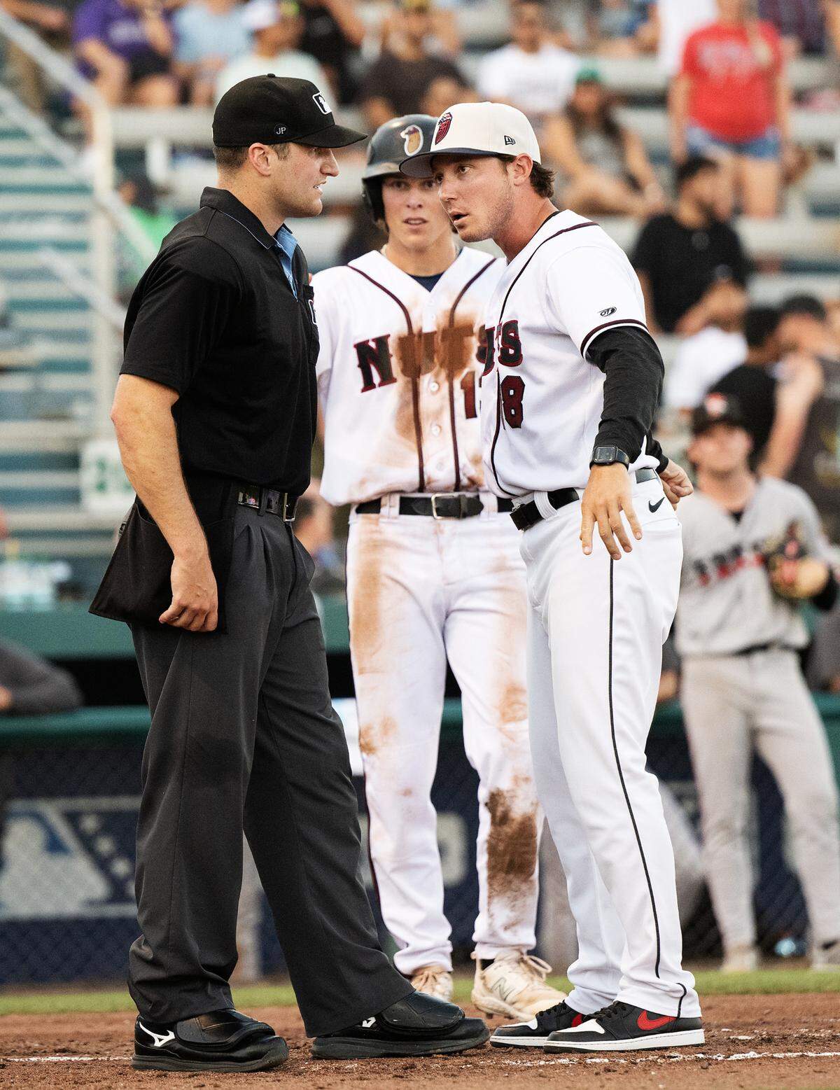 Modesto Nuts manager Zach Vincej, right, challenges a call with plate umpire Drew Boffeli during the game with Fresno at John Thurman Field, in Modesto, Calif., Wednesday, July 3, 2024. Modesto won the game 6-3.