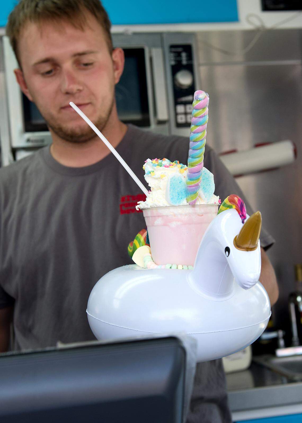 Matt Jarema holds the unicorn shake at OMG! Ice Cream at the Stanislaus County Fair in Turlock, Calif., Saturday, July 14, 2018. 