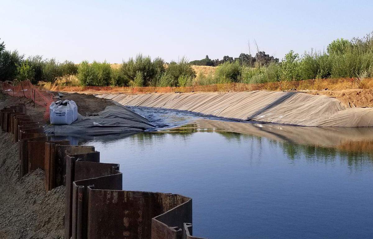 A temporary diversion dam is pictured near Dennett Dam on Tuesday August 21, 2018 in Modesto, Calif. City of Modesto crews worked to remove the dam.