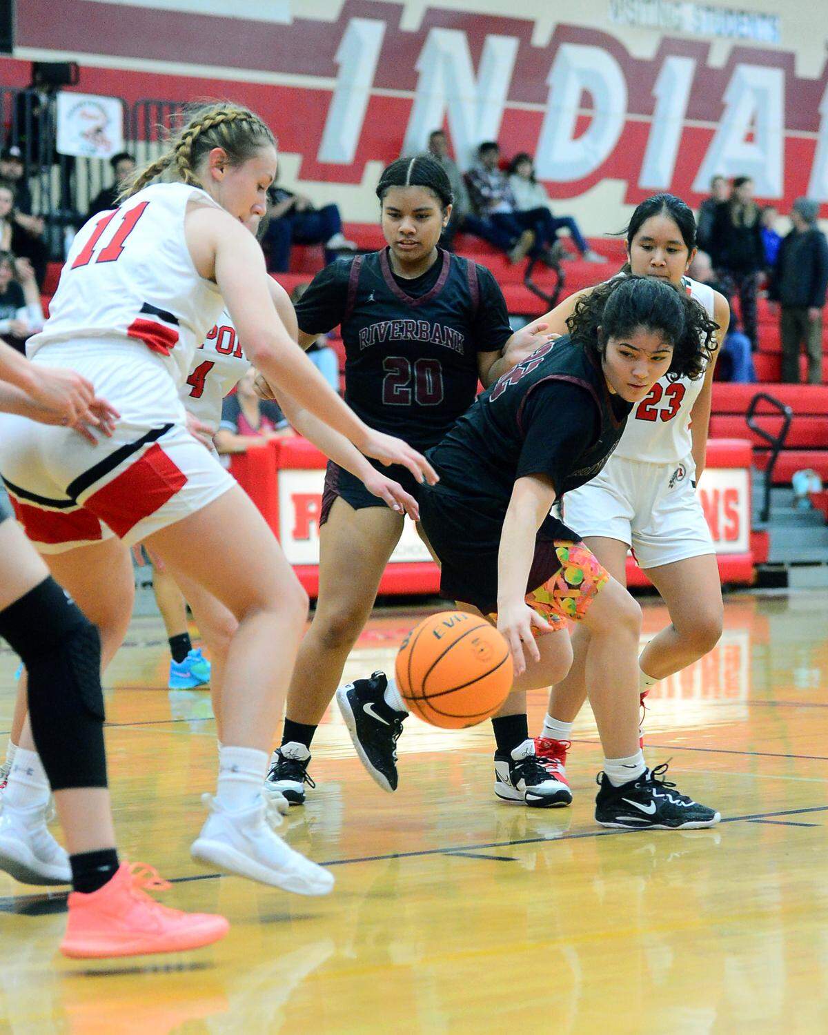 Riverbank’s Kiera Fagundes reaches for a loose ball during a game between Ripon High School and Riverbank High School at Ripon High School in Ripon California on January 5, 2023.