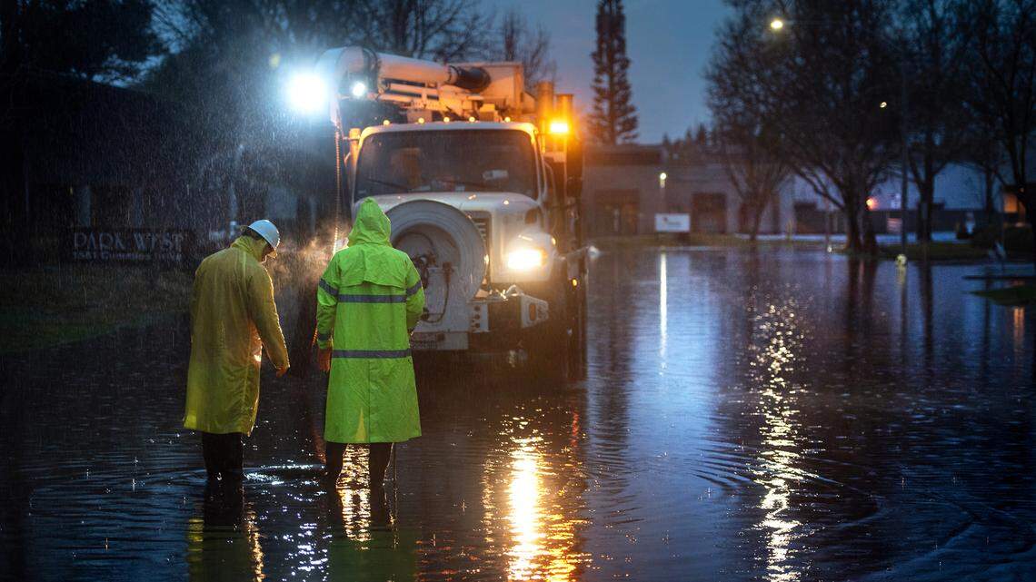 Modesto city workers work to clear rain water from Cummins Drive in Modesto, Calif., on Thursday, Jan. 28, 2021.