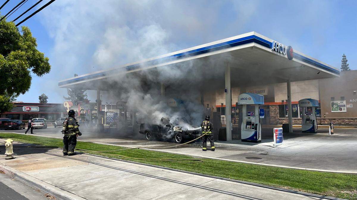 MFD crews work to extinguish a vehicle fire Thursday afternoon at gas station on Coffee Road.