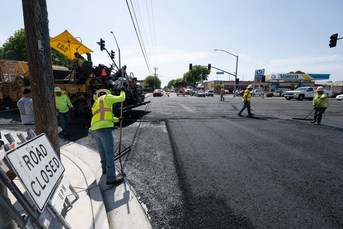A crew from United Pavement Maintenance Inc. resurfaces Orangeburg Avenue from Coffee Road to Oakdale Road in Modesto, Calif., Thursday, June 22, 2023.