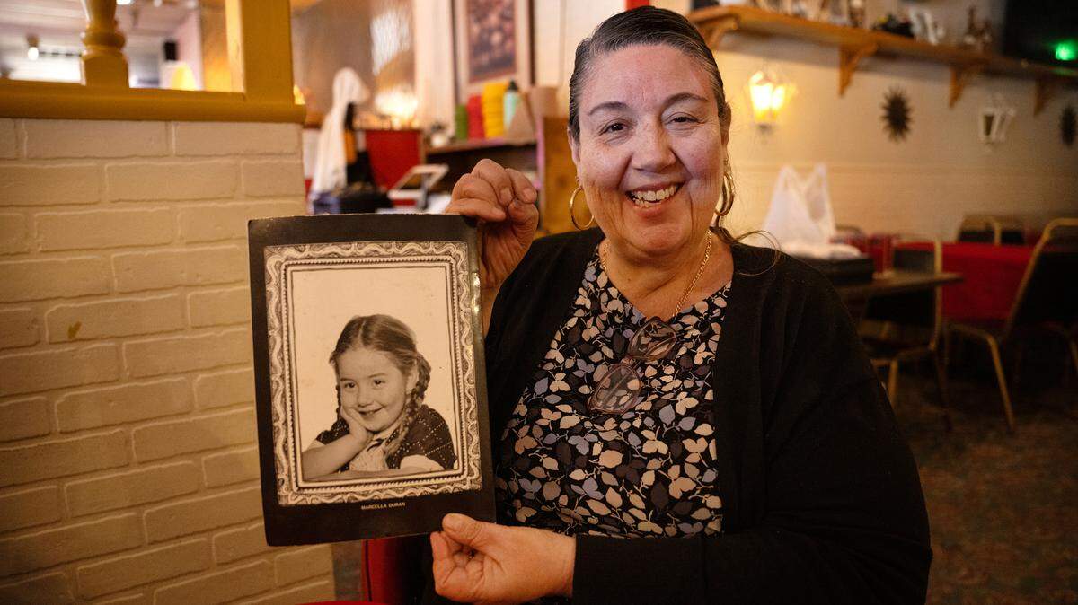 Marcella Garcia holds a menu from the restaurant her father, Alfredo Duran Sr., opened, named after her with her portrait on the back. Marcella’s Mexican restaurant is closing at the end of the month. Photographed in Modesto, Monday, Jan. 13, 2025.