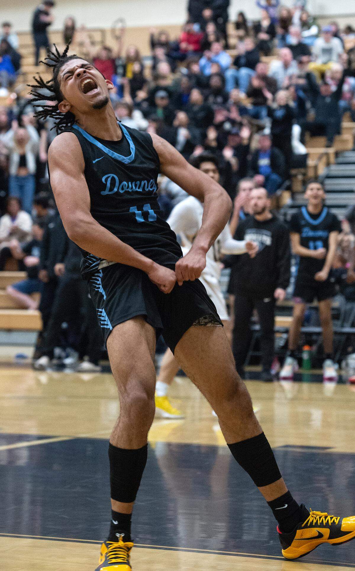 Downey’s Lloyd French reacts after dunking the ball on a fast break during the Central California Athletic League with Enochs at Enochs High School in Modesto, Calif., Friday, Jan. 27, 2023. Downey won the game 47-40.