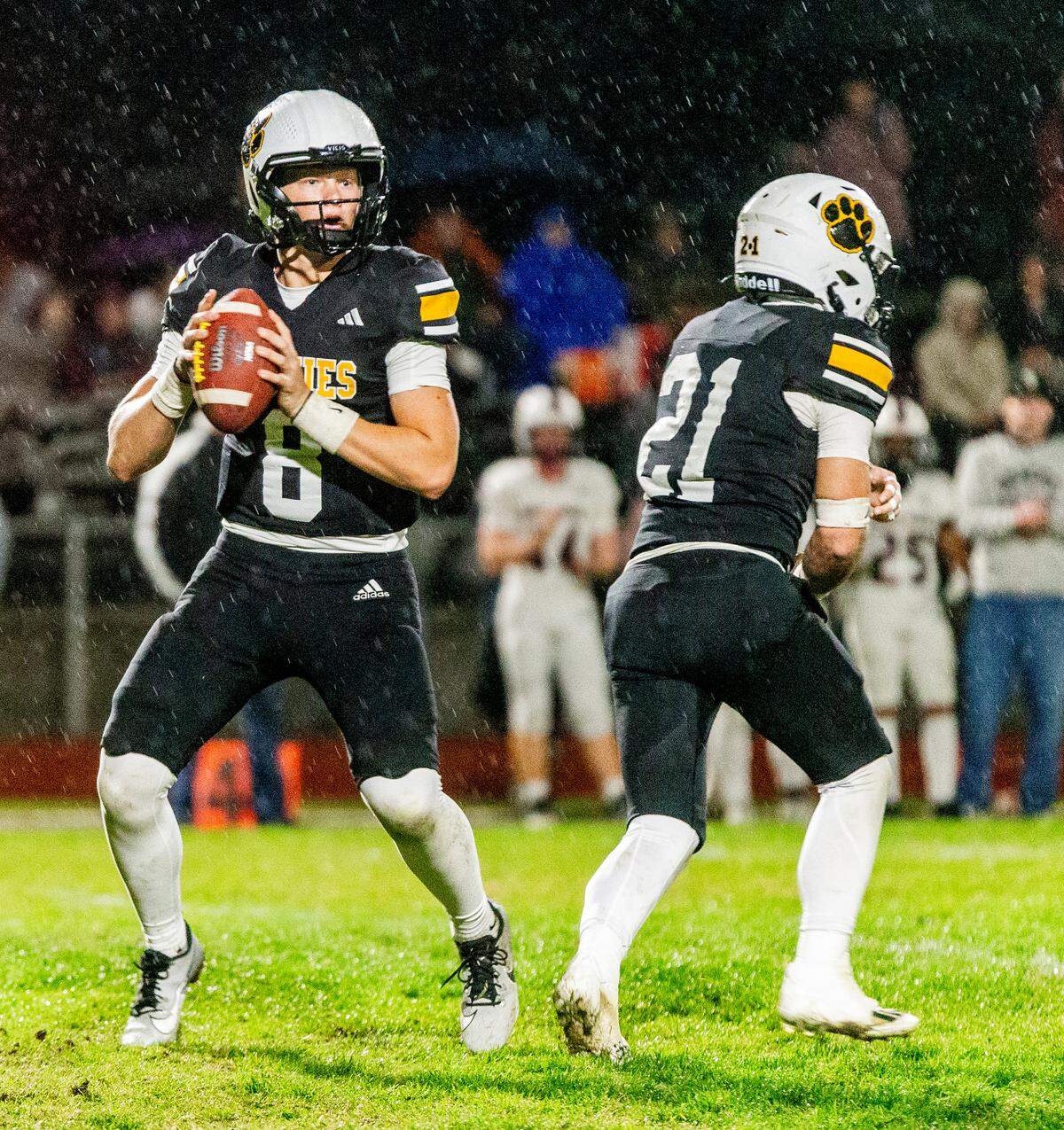 Robert McDaniel, 8, looks upfield for an open man with Eli Wilbanks, 21, preparing to block during the Sac-Joaquin Section Division V Semifinals against Union Mine on at Hughson High School on Friday, Nov. 22, 2024.