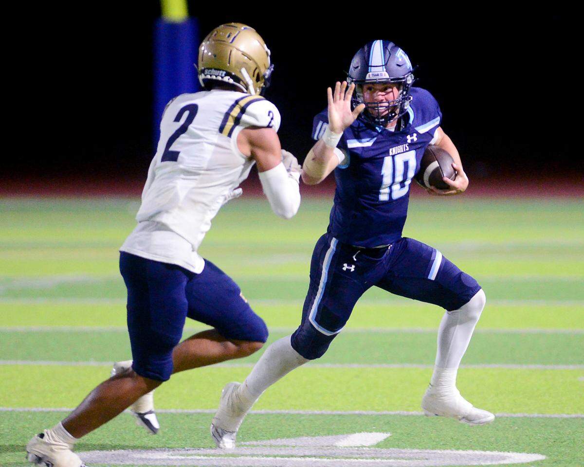 Downey quarterback Carson Lamb (10) stiff arms an Elk Grove defender during a game between Downey High School and Elk Grove High School at Downey High School in Modesto, Calif. on August 30, 2024.