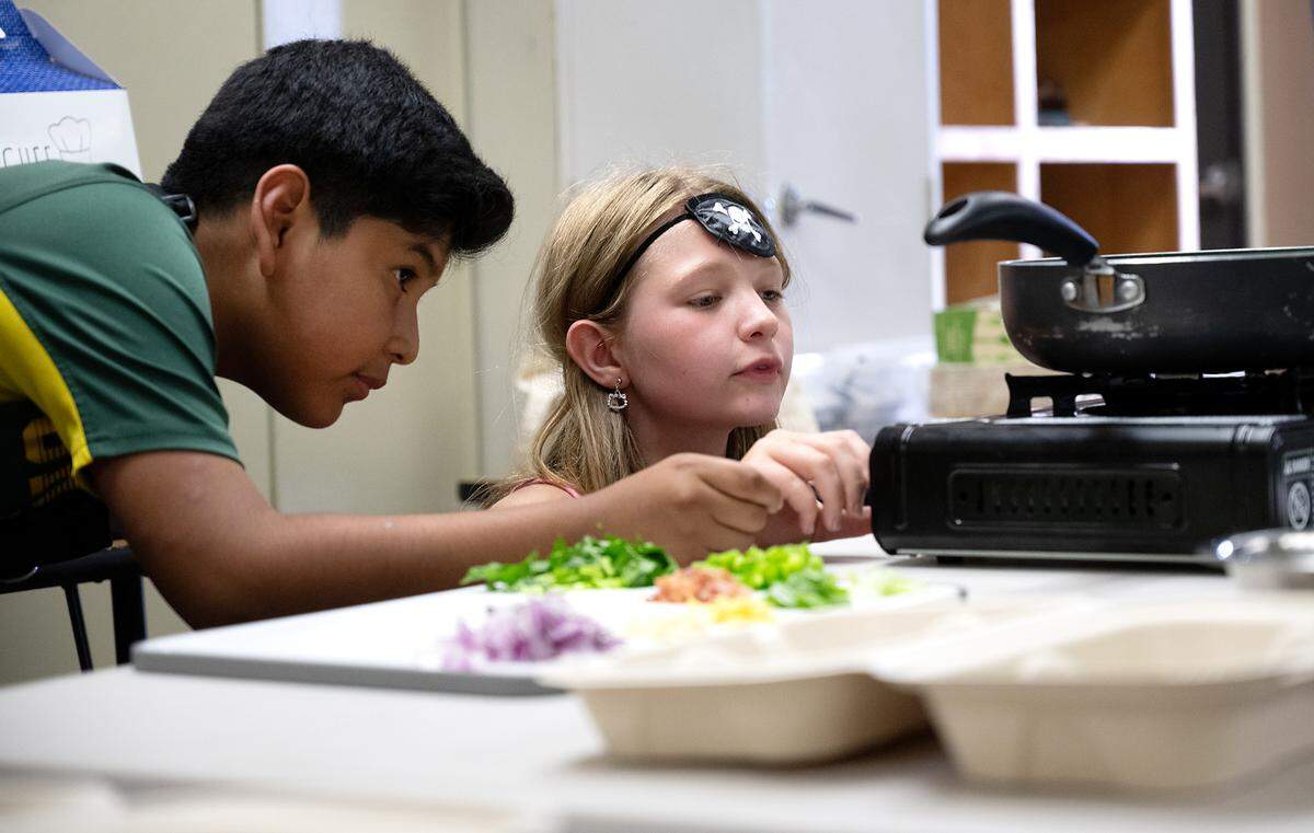 Jonathan Sandoval, left, and Kaelyn Day prepare the gas stove during the Junior Chef after school program at Sipherd Elementary School in Modesto, Calif., Thursday, Sept. 19, 2024.