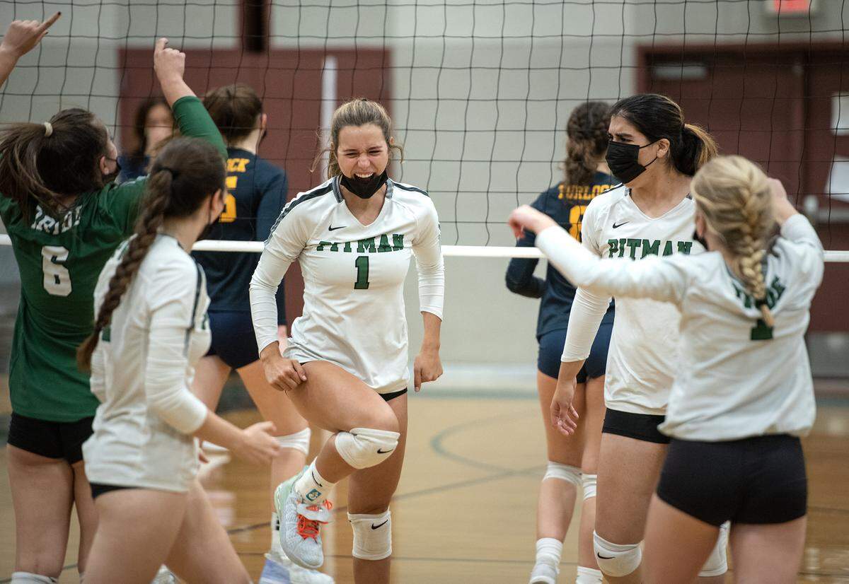 Pitman’s Mimi Verdone (1) and her teammates celebrate a point during the Central California Athletic League match with Turlock at Pitman High School in Turlock, Calif., on Tuesday, Sept. 28, 2021. Pitman won the match 3-0.