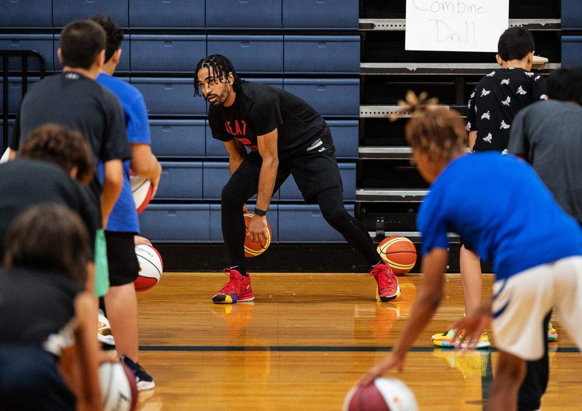 Modesto native and NBA player Gabe Vincent leads a ball-handling drill during the Modesto Slam-N-Jam basketball camp at Big Valley Christian in Modesto, Calif., on Tuesday, July 6, 2022.