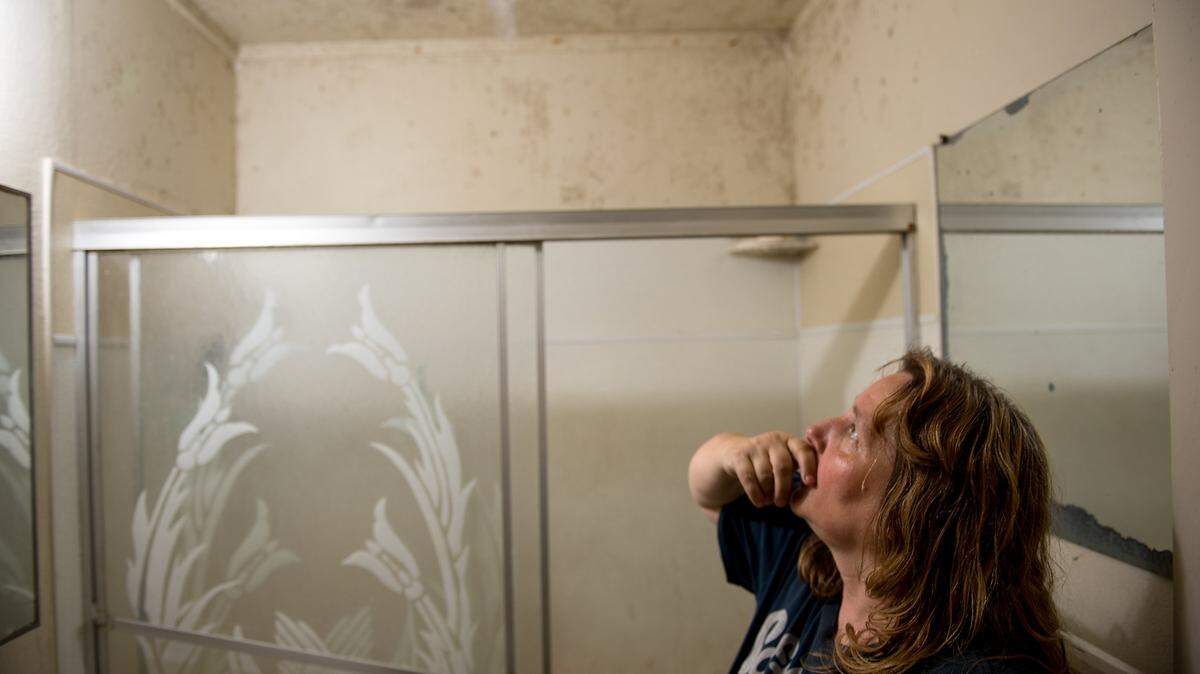 Karen Garcia looks up at mold in her bathroom, she says she cannot control it with just bleach. Garcia lives in a three-bedroom, one bath unit at Suncrest Apartments in Modesto, Calif. She is pictured Tuesday, July 17, 2018.
