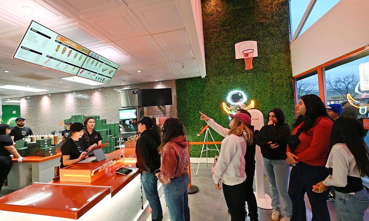 People line up to order corndogs during the grand opening of Corn’d Korean Corndogs in Turlock, Calif., Tuesday, Feb. 13, 2024.