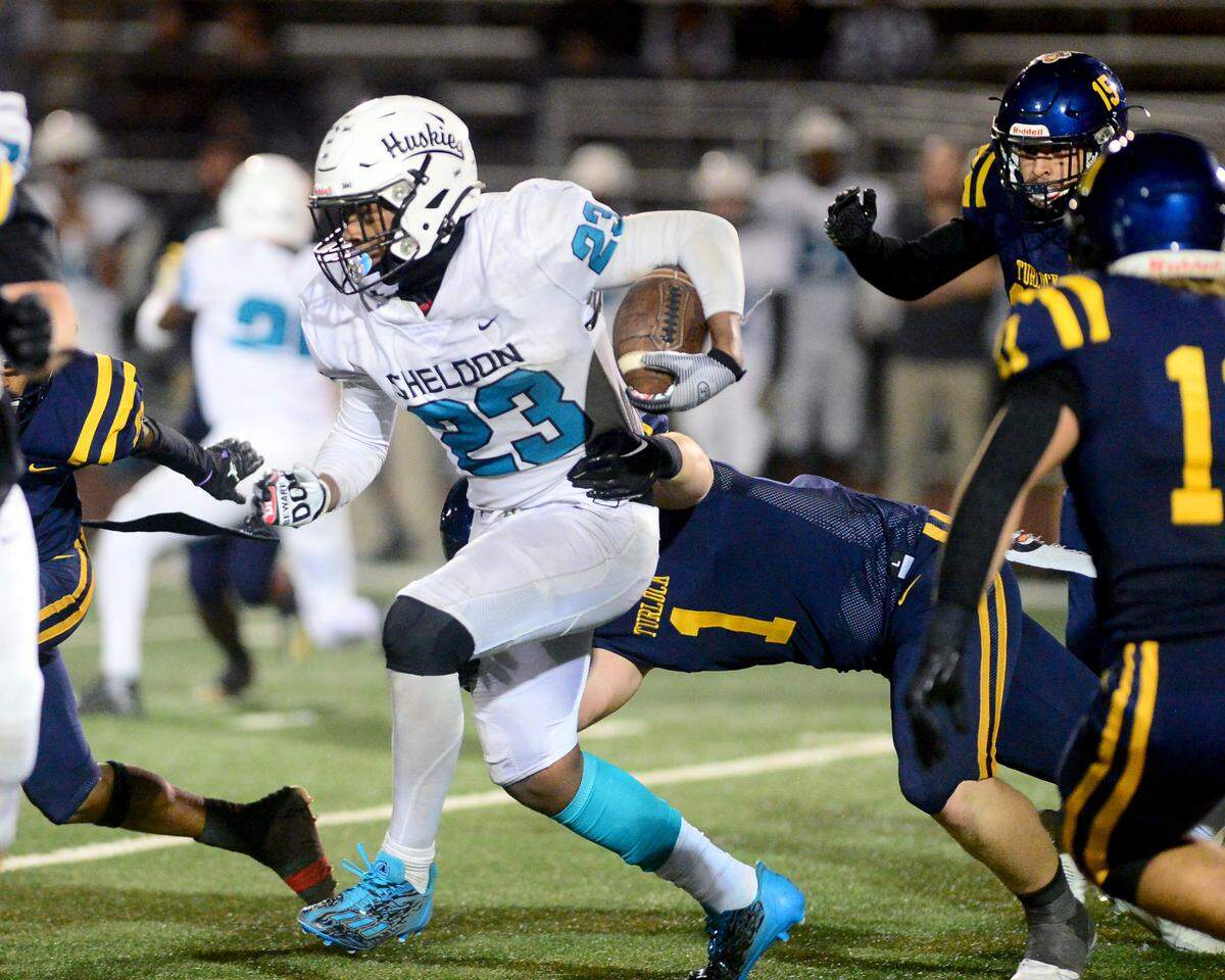Sheldon running back Zayden Learson (23) battles for yards during a CIF Sac-Joaquin Section Football Division I playoff game between Turlock high School and Sheldon high School at Turlock High School in Turlock, California on Nov. 3, 2023.
