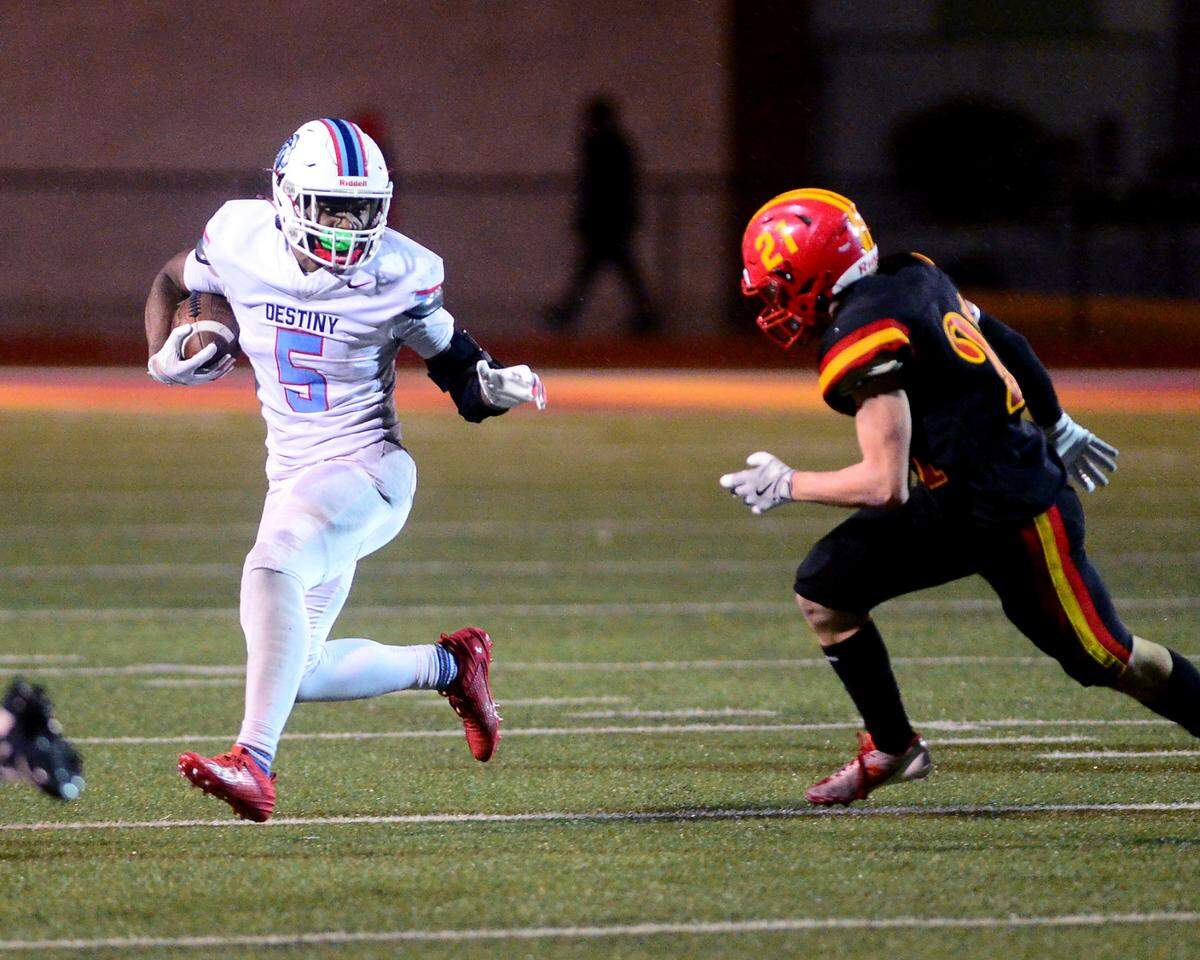 Destiny Christian Academy running back Malakai Taione Tauataina (5) eyes a Oakdale defender during a 2024 CIF Sac-Joaquin Section Division 3 playoff game between Oakdale High School and Destiny Christian Academy at Oakdale High School in Oakdale California on November 22, 2024. Oakdale won the game 49-35.
