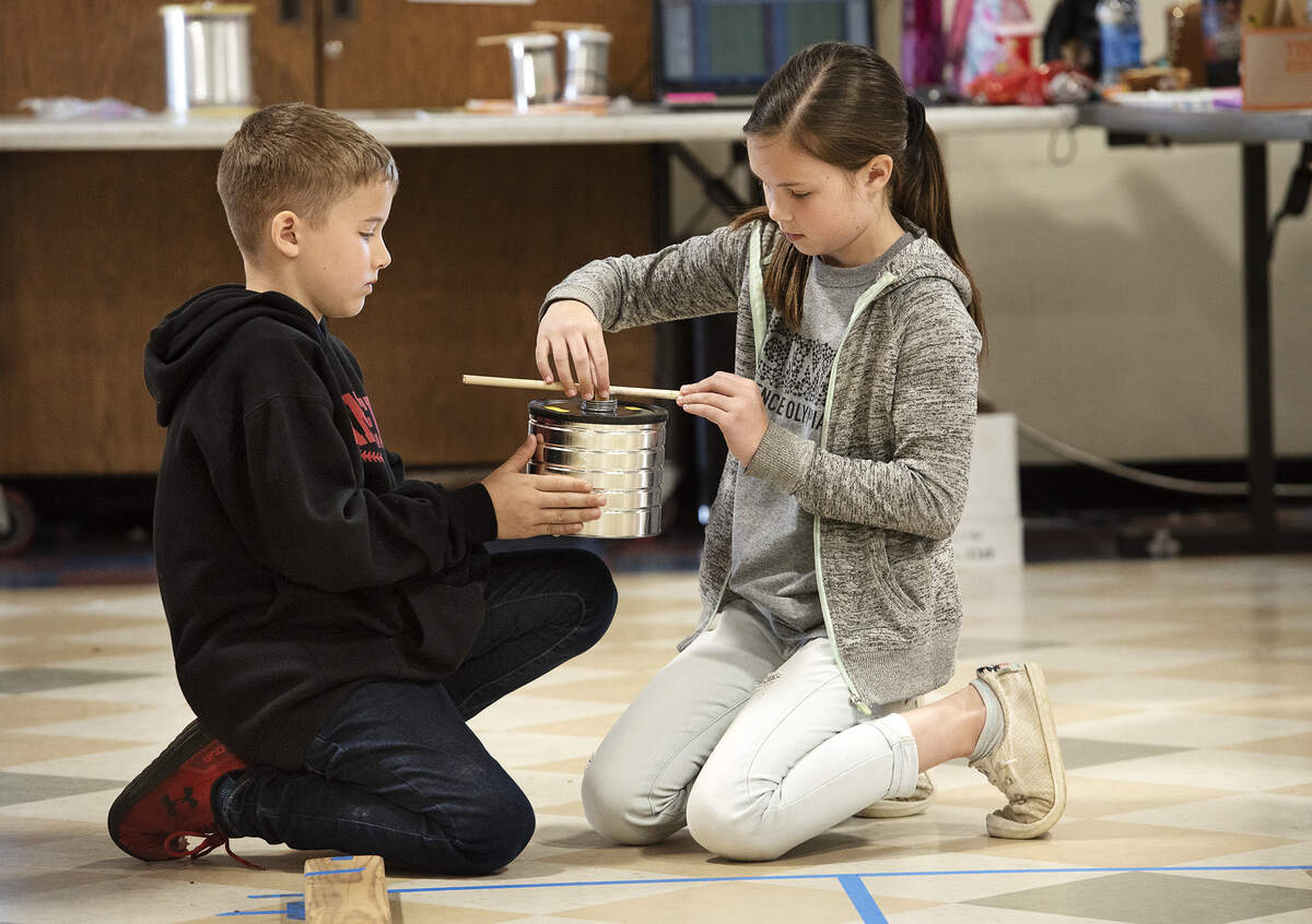 Brother and sister team from Hickman Charter, Maile and Dylan Poling, prepare their vehicle for the can race during the 22nd annual Stanislaus County Elementary Science Olympiad.