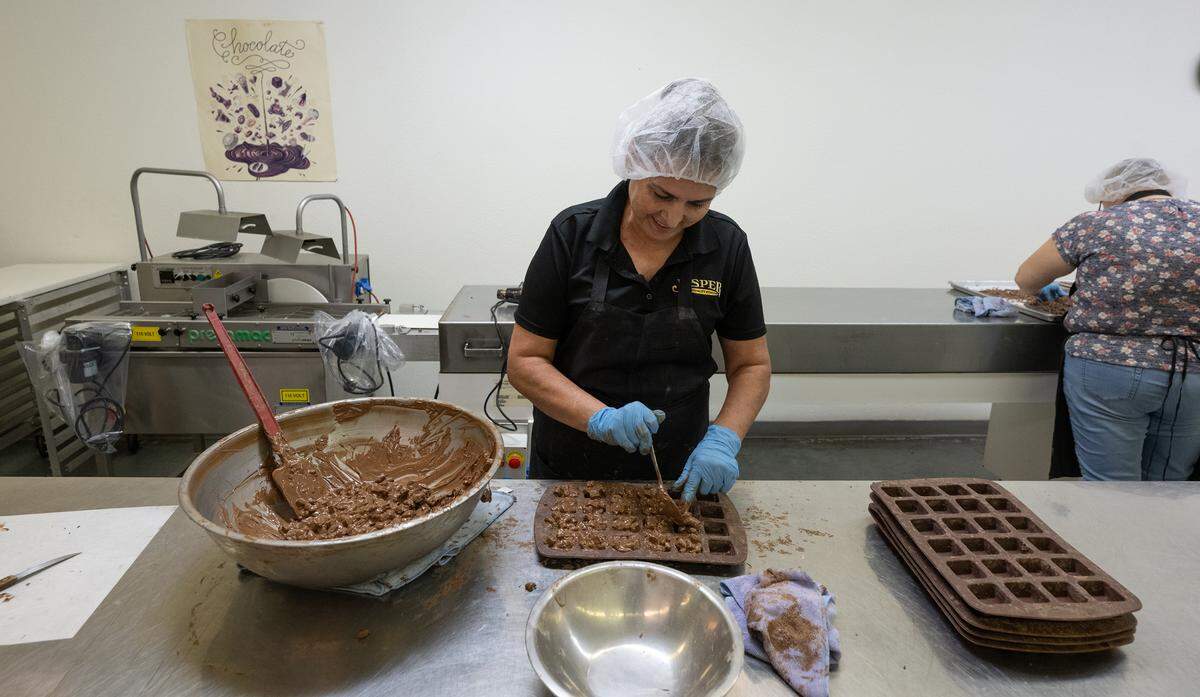 Candymaker Leticia Alvarez prepares rocky road chocolate candy at Jasper’s Specialty Foods in Newman, Wednesday, Oct. 9, 2024.