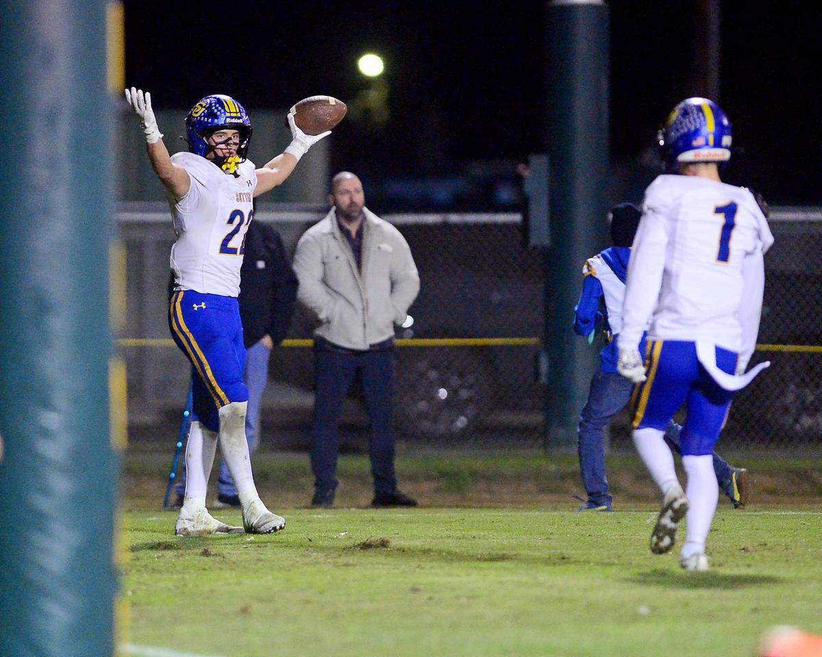 Sutter Huskies running back Max Bringgold (22) celebrates a touchdown during  a Sac-Joaquin Division V semifinal game against Hilmar in Hilmar on Friday.