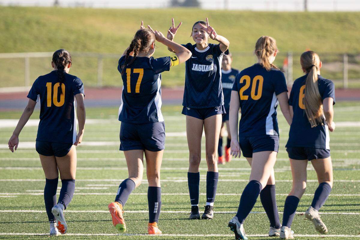 Gregori players Alison Hou (17) and Kylie Farmer, middle, celebrate a goal during the Central California Athletic League game with Downey at Gregori High School in Modesto, Thursday, Jan. 9, 2024. Gregori won the game 7-1.