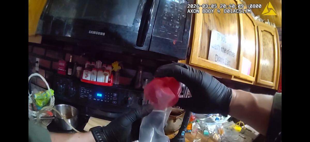 A Tuolumne County sheriff’s deputy examines suspected methamphetamine during the service of a search warrant at a residence in Soulsbyville on March 6, 2026. Five people were arrested and about 3.6 ounces of meth were seized, authorities said.
