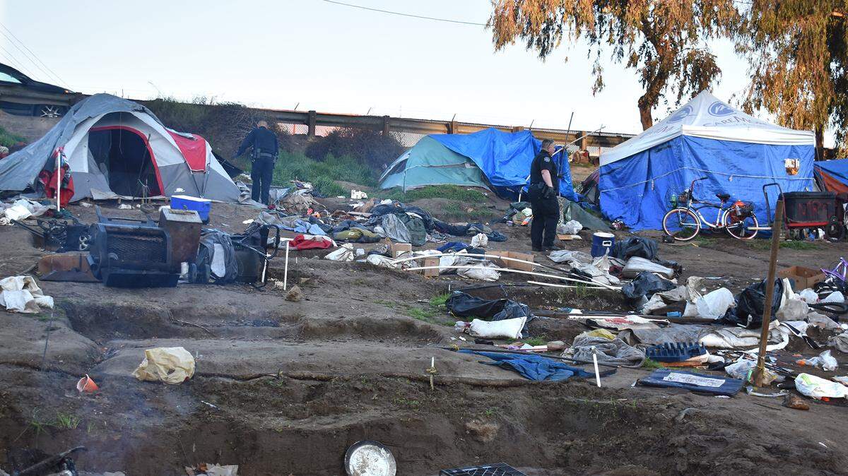 Police ensure tents are vacant in a homeless camp at Modesto’s Beard Brook Park in March 2019.