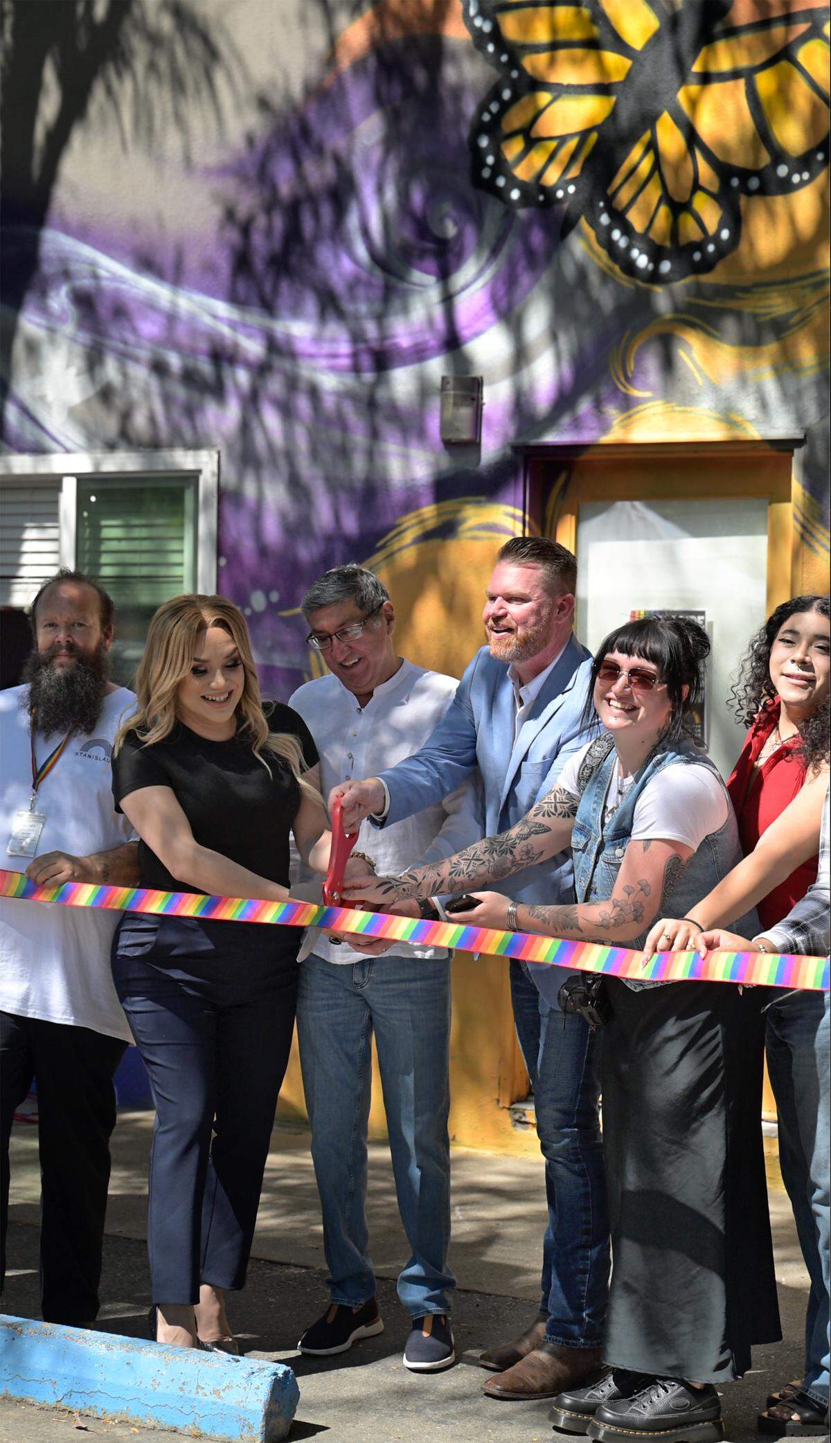 CalPride staff celebrates its grand opening of their resource center with a ribbon cutting in Modesto, Friday, August 1, 2025