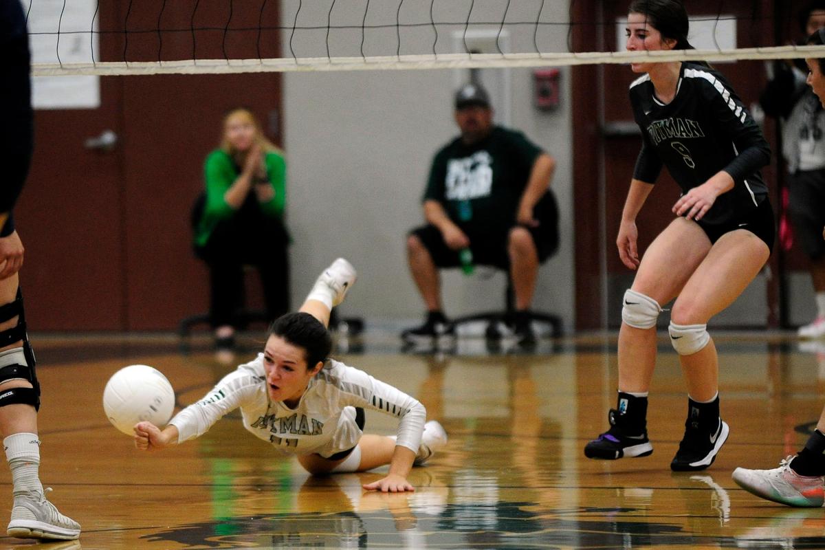 Pitman’s Emma Hirschkorn (11) dives for a dig during the senior night, crosstown volleyball matchup of Turlock High at Pitman High, on Monday, Oct., 15 in Turlock, California.