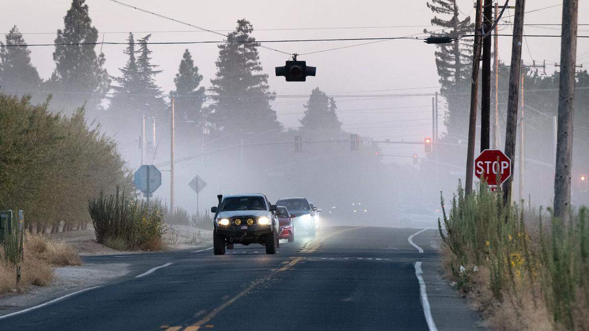 Dust from almond harvesting fills the air on Tully Road in Modesto, Calif., Friday, Sept. 13, 2024.