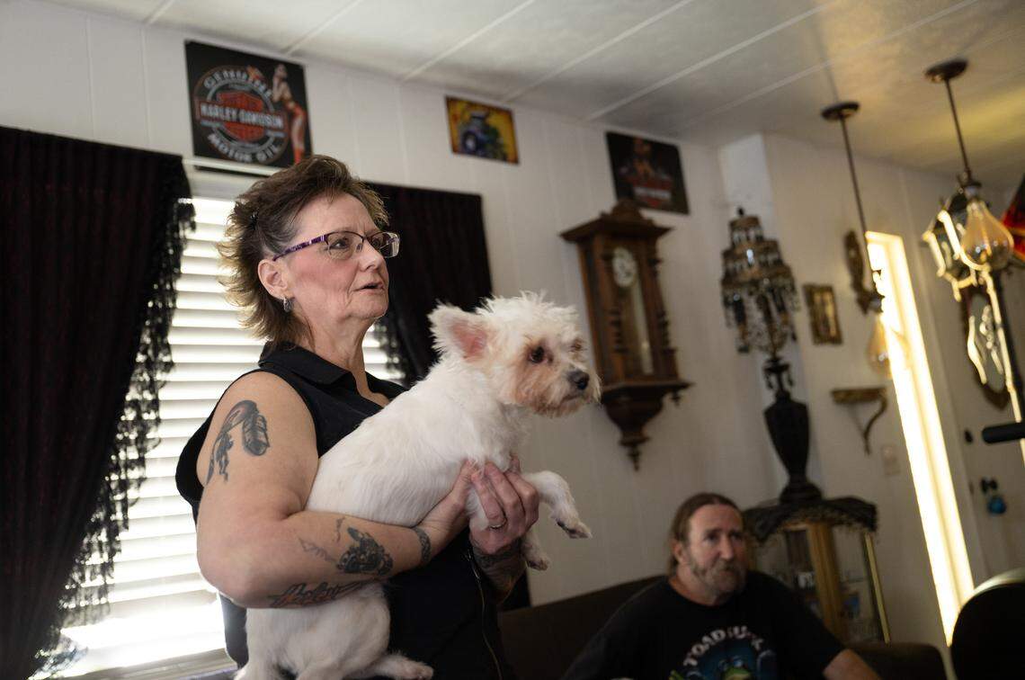 Sabrina Cesena and Robert Roach in their home at Riverview Mobile Home Estates near Hughson, Tuesday, May 20, 2025. They drink bottled water and give it to their dogs as well.