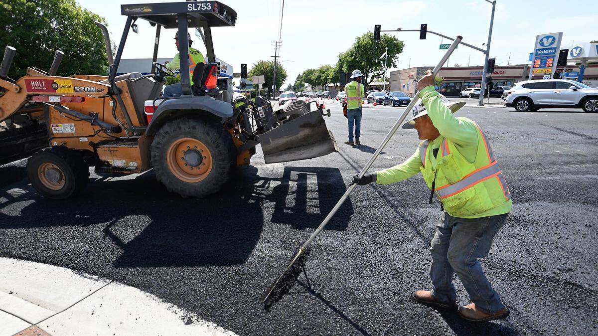 A crew from United Pavement Maintenance Inc. resurfaces Orangeburg Avenue from Coffee Road to Oakdale Road in Modesto, Calif., Thursday, June 22, 2023.