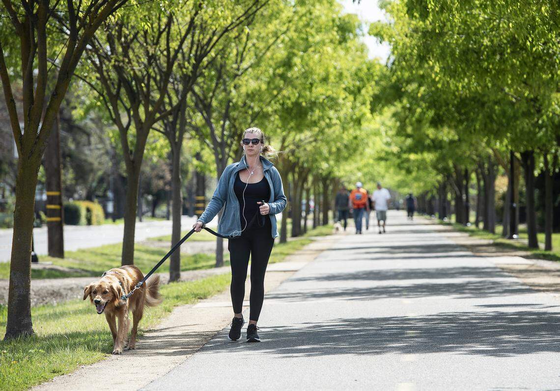 Kristie Morris walks on the Virginia Corridor Trail with her dog Ozzy in Modesto.