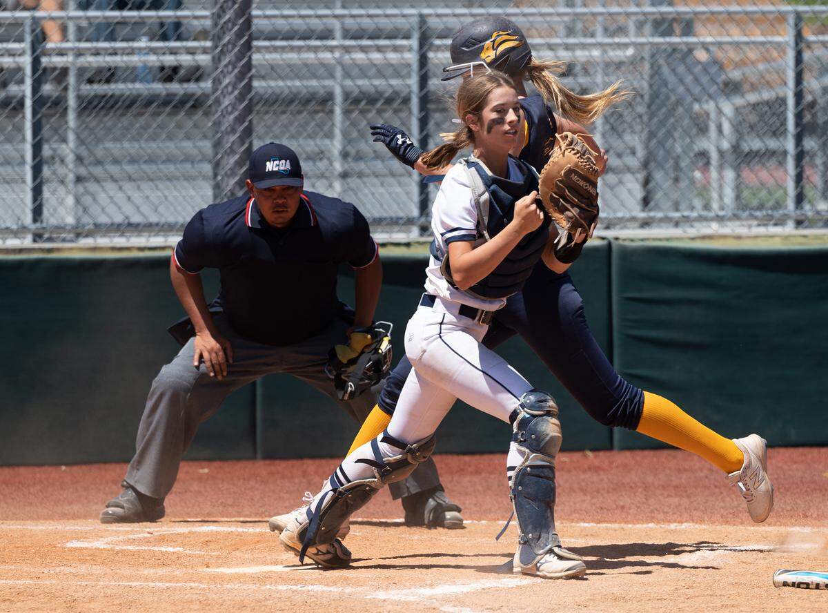 Stone Ridge Christian catcher Caitlyn Cole forces out Big Valley Christian runner Trinity Beers during the Sac-Joaquin Section Softball Division VII championship game at Delta College in Stockton, Calif., on Saturday, May 21, 2022.