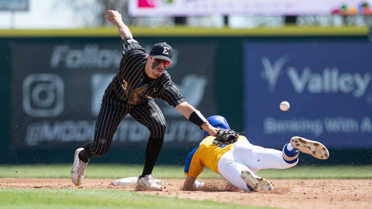 Turlock’s Carter Crivelli slides into second base safely ahead of a throw to Enochs shortstop Ryan Silva during the showcase game at John Thurman Field in Modesto, Calif., Friday, March 31, 2023.