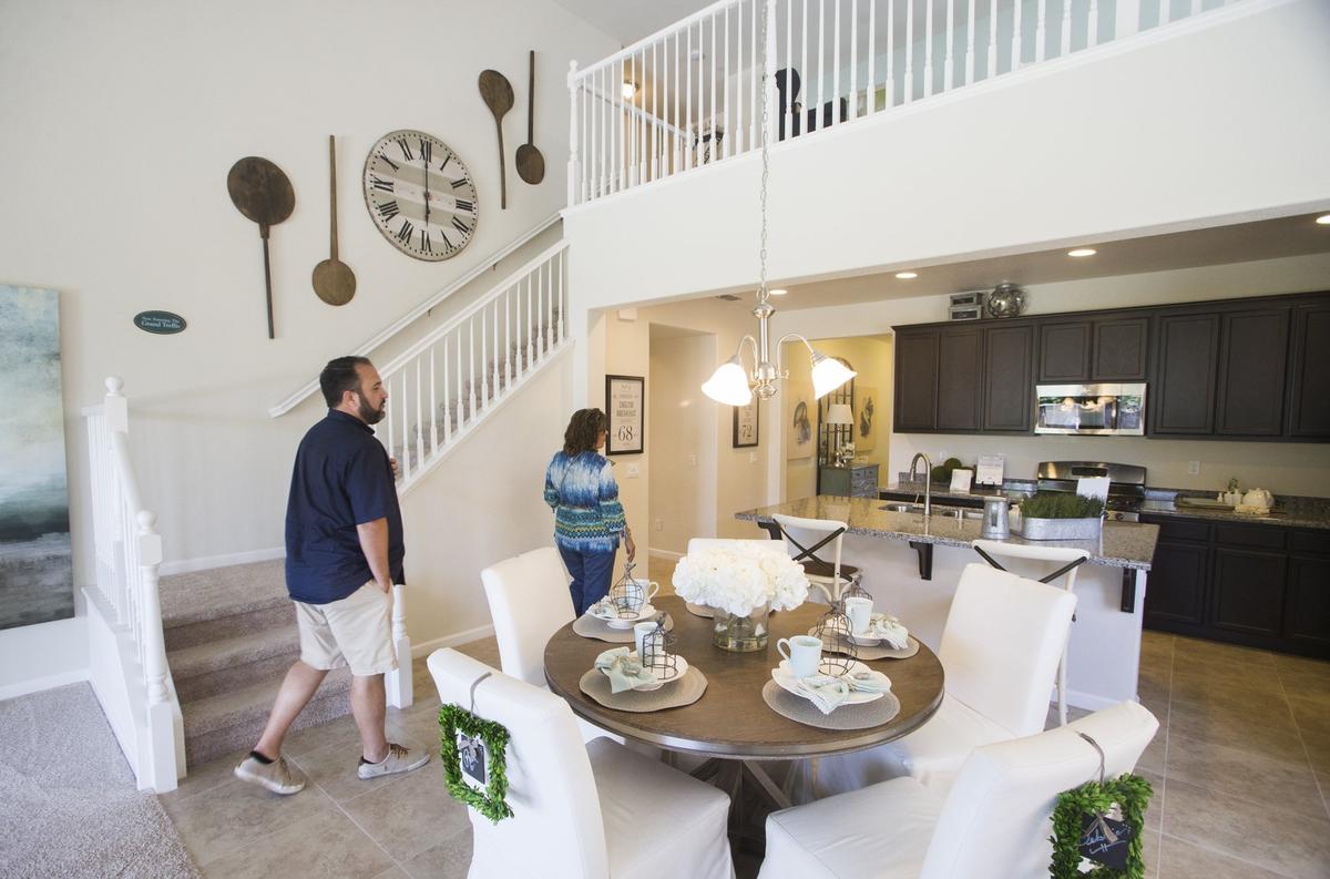 Ninus Benjamin along with his mother Agnes Benjamin look at one of several display homes at a new Florsheim Homes subdivision in Modesto, CA. New homes are starting to pop up again as the market improves and people begin to buy new homes again. Show homes on Spring Oak Drive in north east Modesto attracted home shoppers from around the area Sunday June 17, 2018.